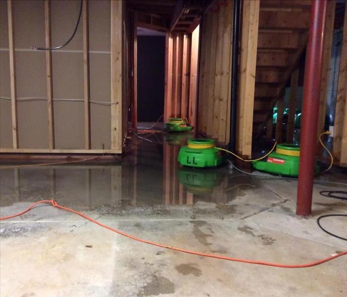 Wet basement floor with SERVPRO drying equipment
