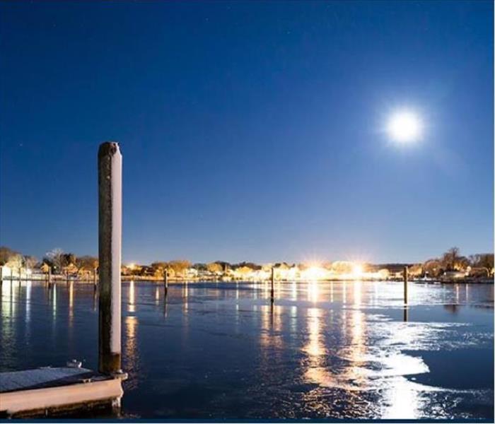 night view of moon and dock on water